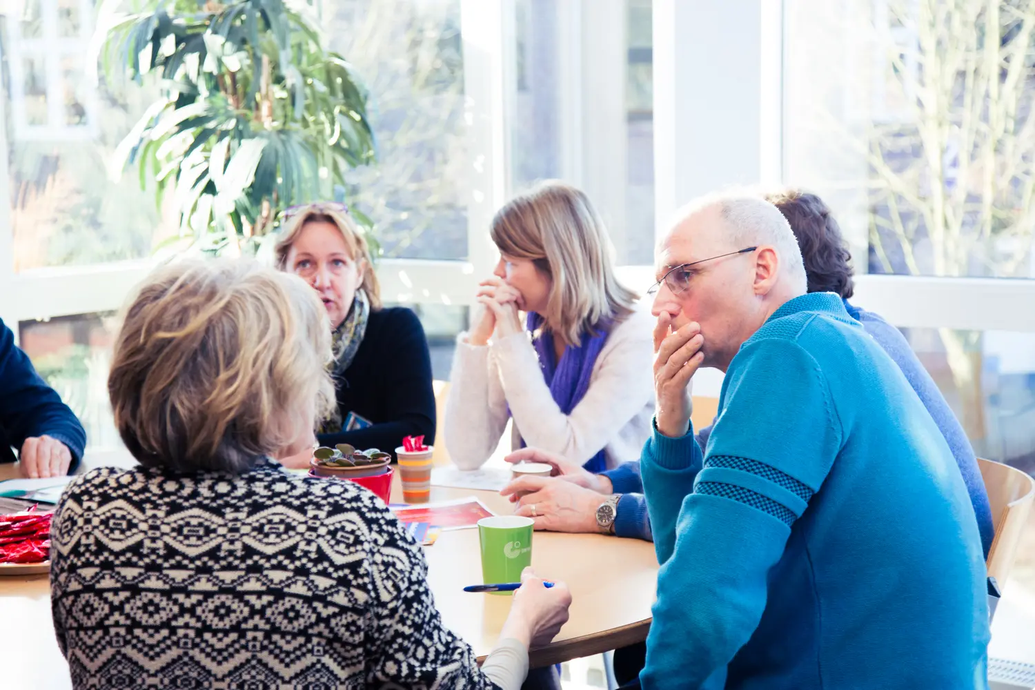 Een groepje klachten zit rond een tafel. School en Veiligheid